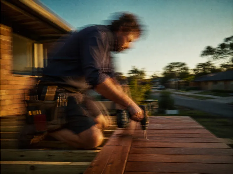 Carpenter screwing down decking